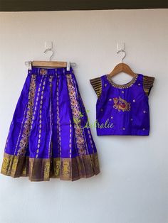 Happy Hues- Electric Festive Wear Make this festival season even more special for your little darling with this limited edition. BUYER'S PLEASE LEAVE YOUR CONTACT NUMBER. It's necessary for shipping. Fabric and Work The traditional pattu pavadai and choli is made of a pure Kanchipuram silk with pure zari boarder. The choli is embellished with a beautiful peacock motif made by golden zardozi, beads and silk thread. Small pleated sleeve gives it an elegant look. It's a perfect dress for baby girls Royal Festive Lehenga, Royal Zari Work Sets For Festive Occasions, Royal Sets With Traditional Drape For Festive Occasions, Royal Festive Sets With Traditional Drape, Royal Traditional Wear With Pallu For Festive Season, Royal Embroidered Sets For Festive Occasions, Royal Saree For Festivals, Royal Embroidered Festive Sets, Blue Art Silk Sets For Celebration