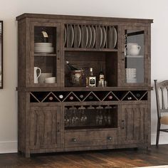 a dining room hutch with wine glasses and plates