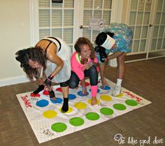 three people are playing with an interactive game on the floor