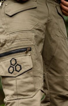 The Psy Cargo Trousers are perfect for all occasions! Featuring 6 front pockets, 4 side cargo pockets, 2 back pockets, 1 waterproof pocket with waterproof closing zip and one 1 secret pocket. Also featuring a metal buckle. The geometric and lotus designs on the pockets are subtle yet distinct in style. These pants are perfect for festivals or just getting around hands-free in comfort and with convenience! Sizes (inches) S = 30-32 M = 32-34 L = 34-36 XL = 36-38 MEASUREMENTS: S: Top of waistband: Military Cargo Pants With Functional Pockets For Hiking, Practical Cargo Pants With Multiple Pockets For Outdoor, Practical Khaki Cargo Pants With Pockets, Practical Outdoor Pants With Pockets, Practical Cargo Pants With Side Pockets For Outdoor, Practical Outdoor Cargo Pants With Side Pockets, Techwear Cargo Pants With Belt Loops For Hiking, Utility Outdoor Bottoms With Zipper Pocket, Practical Pants With Multiple Pockets For Outdoor Work