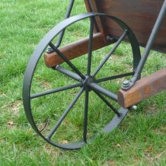 an old wooden wagon with wheels on the grass