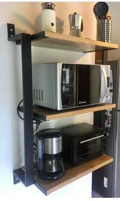 there is a microwave, coffee maker and other kitchen items on the shelve