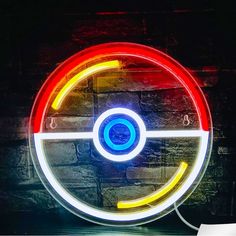 a pokemon poke ball neon sign on a brick wall