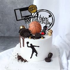 a birthday cake decorated with basketballs, cookies and other sports related items is shown