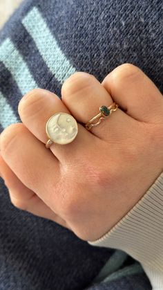 15mm white or natural mother of pearl disc engraved with a crescent moon and star.  Rings are handmade using gold filled or sterling silver components.   Please be sure to properly measure for your ring size as these rings are custom-made and are not eligible for exchange or return.   Get the matching pendant here: https://www.etsy.com/jacknginger/listing/1073393095/luna-mother-of-pearl-celestial-pendant?utm_source=Copy&utm_medium=ListingManager&utm_campaign=Share&utm_term=so.lmsm&share_time=1629846600328 You may purchase a ring sizer here: https://www.etsy.com/listing/863119713/ring-sizer Gold Celestial Moonstone Ring With Moon Phase, Engraved Moonstone Round Jewelry, Celestial Gold Moonstone Ring With Moon Phase, Round Engraved Moonstone Jewelry, Engraved Round Moonstone Jewelry, Handmade Celestial Opal Ring, Celestial Style Opal Ring, White Round Sun And Moon Design Jewelry, Brass Moonstone Ring