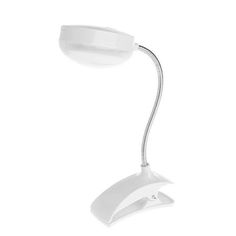 a white desk lamp sitting on top of a table