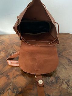 "Backpack bag, brown faux leather backpack,Converts to shoulder bag, mint condition, Whiskey brown Top loop handle for carrying Flap over and Snap clasp closure. 2 front snap close pockets PLEASE SEE MEASUREMENTS Measures: 12\" tall x 10\" x 5.5\" deep Straps: adjustable Should strap drop is 12\" NK216B3 Backpack bag, brown faux leather backpack,Converts to shoulder bag, mint condition, Whiskey brown" Vintage Brown Backpack For On-the-go, School Satchel Bucket Bag With Adjustable Strap, Brown Tote-shaped Bucket Bag For School, Brown Shoulder Bag With Removable Pouch For School, Brown Shoulder Bag For School With Removable Pouch, Brown Leather Backpack With Large Capacity For School, Faux Leather Backpack With Shoulder Straps, Brown Leather Backpack With Adjustable Strap For On-the-go, Brown Tote Shoulder Bag For School