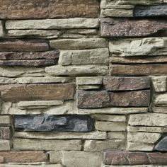 a stone wall with several different colors and shapes