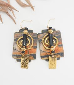 Listing is for a Vintage Artisan Chinese safari print bronze architectural tribal earrings.  Very nicely made earrings with black onyx? accent and dangle drop Chinese hieroglyph symbol. Earrings have safari print, bronze and paper coated with paint. Earrings measure 2.4" x 0.9".  Good vintage condition! thank you. (N132) Artistic Black Dangle Jewelry, Black Artistic Jewelry, Black Jewelry With Artistic Design, Artistic Black Drop Earrings, Black Earrings With Artistic Design For Gift, Black Earrings With Artistic Design As A Gift, Bronze Metal Jewelry With Artistic Design, Artistic Bronze Metal Jewelry, Unique Black Rectangular Jewelry