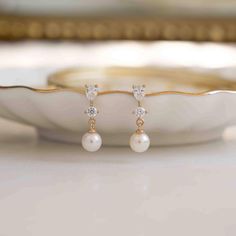 Delicate and timeless, these Pearl Drop Diamond Earrings are made of natural pearls. They are dainty and minimalist and adds a nice touch of elegance to any look!  ✨ Features You'll Love * Made of 925 Sterling Silver * THICK plating of 14k Gold or Rhodium * Sold as a PAIR * 16mm Long * 5mm Natural Pearl  * Nickel-free & Hypoallergenic (great for sensitive ears!) * Push Back Closure Comes in a gift-box, ready for gift-giving! 🎁 Ships same day for fast delivery! ✈️ Made with 100% Pure Love! ♡ Hap Dainty Earrings Silver, Drop Diamond Earrings, Pearl Earrings Drop, December Birthstone Jewelry, Pearl Jewelry Wedding, Bridesmaid Gifts Jewelry, Chunky Earrings, Studded Necklace, Earrings Christmas