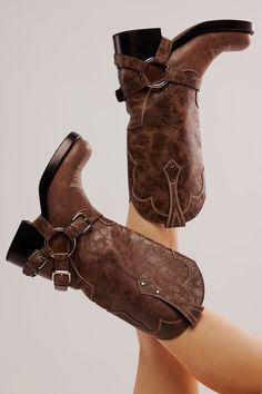 These tough leather boots infuse a classic motorcycle style with Western charm, featuring chunky harness and buckle details and instantly recognizable cowboy embroidery for a pair ready for a rugged rodeo. Fit: Tall style, pull-on design Features: Leather uppers, square toe, pull straps, dipped toplines, Western-inspired stitching, harness and buckle detailing, chunky block heel Designed by Understated Leather, created by Jeffrey Campbell, and exclusive to FP, these one-of-a-kind boots are an el Cowboy Embroidery, Cowboy Silhouette, Confident Outfit, Freebird Boots, Upcoming Fashion Trends, Square Toe Cowboy Boots, Classic Cowboy, Classic Motorcycle, Leather Western Boots