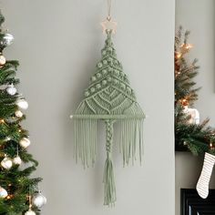 a green christmas tree hanging from the side of a wall