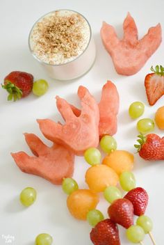 fruits and vegetables are arranged on a white surface