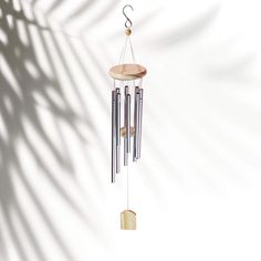 a wind chime hanging from the side of a wall