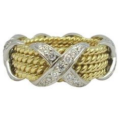 TIFFANY & Co. Schlumberger 18K Gold Platinum Diamond Rope Four-row X Ring 5.5 Metal: 18K gold and platinum Size: 5.5 Width: 8.6mm at the widest point Weight: 11.80 grams Diamond: round brilliant diamonds, carat total weight .54 Hallmark: TIFFANY&CO. SCHLUMBERGER STUDIOS 750 PT950 Condition: Excellent condition, like new. It comes with Tiffany box Value: $10,300 Authenticity Guaranteed Jean Schlumberger, Tiffany Box, X Ring, Diana Vreeland, Elsa Schiaparelli, Tiffany And Co, American Diamond, Gold Platinum, Tiffany & Co.