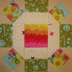 a patchwork quilt with colorful designs on it