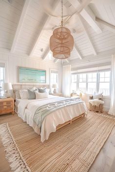 a bedroom with a large bed and white walls