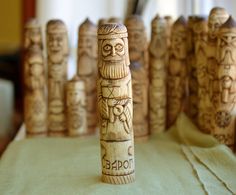 a group of wooden carved figurines sitting on top of a table