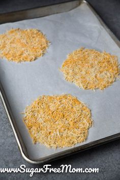 three uncooked cheeses on a baking sheet