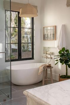 a white bath tub sitting next to a window