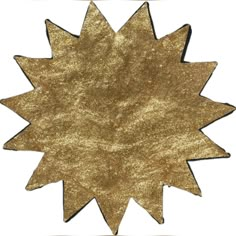 a gold glitter star decoration on a white background