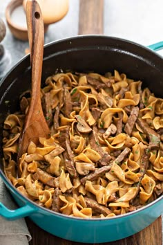 a skillet filled with pasta and beef