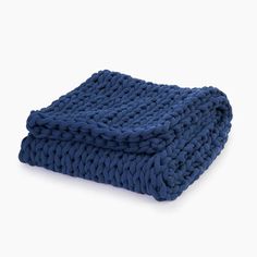 a blue knitted blanket folded on top of each other