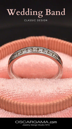 a wedding band is sitting on top of a pink cloth