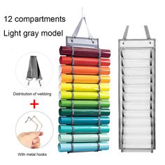 an assortment of different colors and sizes of paint rollers hanging on a rack with metal hooks