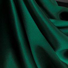 Hunter Green Pure Mulberry Silk Fabric Width 44 inch (112 cm), Industry Thickness : 19 m/m (Momme) Content: 100% Pure Silk Silk Charmeuse Fabric possesses not only the finest aesthetics, but retains the fluid sophistication most sought after in silk fabrics. At the top of its class, Charmeuse Fabric is a satin weave that allows this fabric to retain a soft feel and supple drape that most high-end designers crave, this fabric has many applications as it is composed of both a shiny face on one sid Green Silk Curtains, Luxury Silk Fabric For Formal Occasions, Emerald Green Silk Fabric, Deep Green Fabric, Green Fabric Aesthetic, Green Silk Wallpaper, Green Silk Suit, Emerald Green Color Palette, Abundance Journal