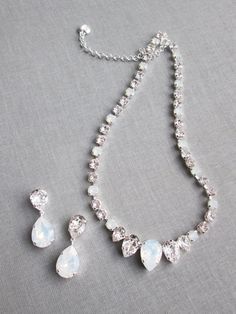 "This elegant necklace and the earrings set is hand made using fine Swarovski crystals in white opal and clear crystal mix. The necklace measures 16\" long and comes with the 2\" extender. The matching drop earrings measure 1 1/2\" long and 1/2\" wide. The set is available in gold, silver or rose gold finish. Also available with all clear crystals. - The listing is for the jewelry set only - For the matching belt please take a look here: https://www.etsy.com/listing/751689969/swarovski-crystal-b Dazzling White Sterling Silver Jewelry Sets, Crystal Dangle Jewelry With Stones, Elegant Teardrop Stone Jewelry, Formal White Jewelry Sets With Sparkling Stones, Teardrop Crystal Jewelry With Stones, Silver Crystal Bridal Necklace With Gemstones, Exquisite Crystal Jewelry With Matching Earrings, Fine Jewelry White Crystal Jewelry Sets, Fine Jewelry Crystal Jewelry Sets In White