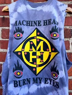 Description: Show off your vintage style with our 1994 Vintage Machine Head Burn My Eyes Tank! Made from high-quality materials, this tank features a cool and attractive graphic that will make you stand out. Perfect for music fans and fashion enthusiasts alike. Available in size XL. Material: 100% Cotton Size: XL Length: 28.5” Chest: 46” Label: unbranded sold as is for sleeves cut Condition: This item is pre-loved Y2k Cotton Tank Top With Graphic Print, Y2k Cotton Graphic Print Tank Top, Cotton Tank Top With Screen Print For Streetwear, Cotton Screen Print Tank Top For Streetwear, Y2k Style Cotton Tank Top For Festivals, Y2k Racerback Top With Graphic Print, Y2k Graphic Print Racerback Top, 90s Letter Print Tank Top For Streetwear, Graphic Print Racerback Top For Streetwear