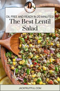 the best lentil salad is in a wooden bowl with a spoon and lemon wedges