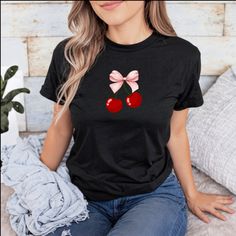 This charming t-shirt features an adorable design of two vibrant red cherries adorned with a lovely pink bow. The playful combination of the red cherries and pink bow creates a fun and eye-catching look that is perfect for adding a touch of sweetness to your outfit. Made from soft and comfortable fabric, this cherry t-shirt not only looks cute but also feels great to wear all day long. Whether you're out for a casual stroll, hanging out with friends, or simply relaxing at home, this t-shirt is a delightful choice. Embrace a playful and stylish vibe with this cherry-themed t-shirt that will surely turn heads wherever you go. Add a pop of color and a hint of whimsy to your wardrobe with this adorable cherry t-shirt that celebrates the beauty of nature in a fun and fashionable way. .: The tea Pink Cotton T-shirt With Cherry Print, Red Crew Neck T-shirt, Trendy Red T-shirt With Strawberry Print, Red T-shirt For Summer Gift, Red Short Sleeve T-shirt For Gift, Sweet Red Crew Neck Top, Red Cherry Print Graphic Tee, Cute Pink T-shirt With Cherry Print, Red Cotton T-shirt With Cherry Print