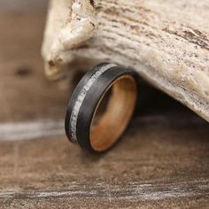 a wooden ring sitting on top of a piece of wood