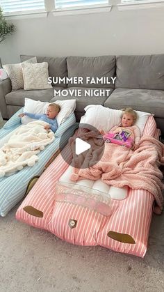 two children laying on pillows in the middle of a living room with text overlay reading summer family movie night