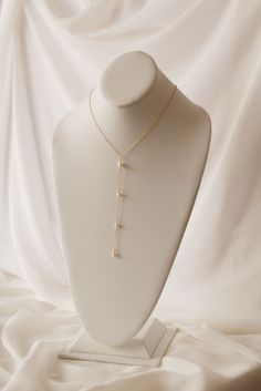 If you're looking for a statement for your big day, look no further. Our Pearl Back Drop Necklace features a 5" front drop and a 7" back drop, adorned with hand fastened freshwater pearls to finish the look. This piece is classic, elegant, and sure to make you like the beautiful bride you are on your special day. Includes 10 freshwater pearls + 16" neck length of 14k gold-filled cable cha Gold Pearl Drop Backdrop Necklace, Gold Backdrop Necklace With Pearl Drop, Dainty Pearl Backdrop Necklace With Pearl Drop, Elegant Pearl Backdrop Necklace With Pearl Drop, Elegant Dangle Backdrop Necklace With Pearl Drop, Pearl Lariat Backdrop Necklace With Pearl Chain, Formal Bridal Pearl Necklace With Adjustable Chain, Classic Long Drop Necklace For Weddings, Adjustable Pearl Pendant Necklace For Wedding