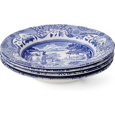 four blue and white plates stacked on top of each other