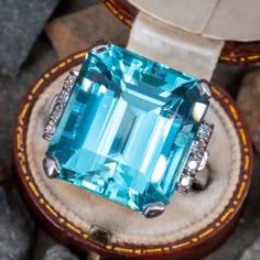 This striking ring is centered with one (1) emerald cut natural aquamarine set into a four-prong setting. The shoulders of the ring are each accented with a row of four (4), bead set, round single cut diamonds. The ring measures 18.6mm at the top, rises 11.5mm above the finger, tapering to 2.5mm wide and 1.8mm thick at the base of the shank. This ring is currently a size 7.75. Aquamarine Stone Ring, Aquamarine Ring Vintage, Aquamarine Cocktail Ring, Find Your Treasure, Blessed Wednesday, Men Rings, Aquamarine Jewelry, Bead Set, Alternative Engagement Rings