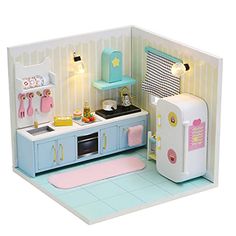 a dollhouse kitchen with refrigerator, stove and sink