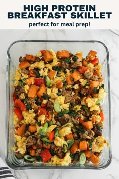 a glass casserole dish filled with eggs, sausage and veggies on a marble counter top