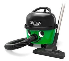 a green and black vacuum cleaner with a hose attached to it's head, on a white background