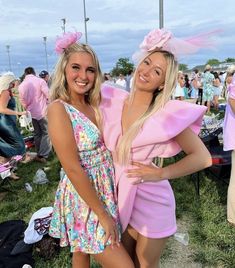 two women standing next to each other in front of a crowd at a music festival