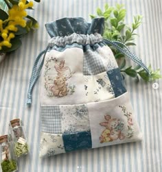 a small bag sitting on top of a table next to flowers