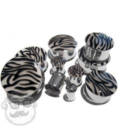 a group of zebra print knobs and covers on a white background with black accents