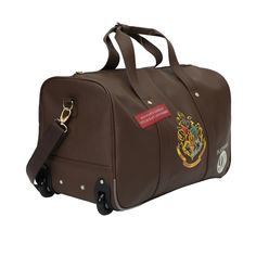 Embark on your next journey in enchanting style with this officially licensed Harry Potter Rolling PU Duffle Bag. Designed with a touch of magic, this duffle bag features patches, applique, and accents inspired by the Wizarding World, making it a must-have for any Harry Potter enthusiast. Inside the spacious main compartment, you'll find ample room to organize and carry your belongings, whether you're heading on a weekend getaway, a business trip, or an adventure to a wizarding destination. Than Themed Travel Bag With Case Included, Rolling Duffle Bag, Harry Potter Travel, Harry Potter Magic, Harry Potter Collection, Travel Games, Travel Channel, Travel Duffel, Luggage Accessories