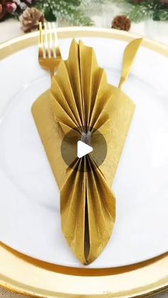 an origami plate with a fork and knife on it is set for dinner