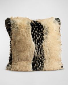 the black and white fur pillow is made from two different pieces of animal hides