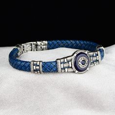 Silver Leather Evil Eye Bracelet , Silver Handmade Bracelet , Blue Sapphire Stone Bracelet , Greek Style Bracelet , 925k Silver Bracelet ★Item Details * Material : 925K Sterling Silver * Total weight :  19 Grams ✔ Ready to Ship in 1-2 Business Days .. ✔ Shipped to the Worldwide 1-5 business days with free shipping... ✔ The product will be sent to you with a handmade wooden box to avoid any damage during shipping... ✔ Visit our store, browse other Men's jewelry, silver and gold collections, and f Adjustable Blue Bracelet For Formal Occasions, Blue Sterling Silver Adjustable Bracelet For Formal Occasions, Blue Sterling Silver Bracelets, Blue Sterling Silver Round Bracelets, Adjustable Sapphire Bracelets For Formal Events, Adjustable Sapphire Bracelets For Formal Occasions, Blue Sterling Silver Bracelet With Silver Clasp As Gift, Elegant Silver Beaded Bracelets With Evil Eye, Blue Sterling Silver Jubilee Bracelet Gift