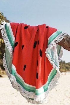 a watermelon towel hanging on a tree branch